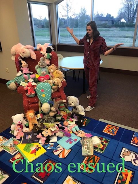 Stuffed animals sitting in chair with staff member surprised