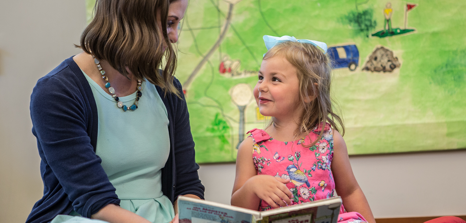 Woman and Young Girl Reading in Book