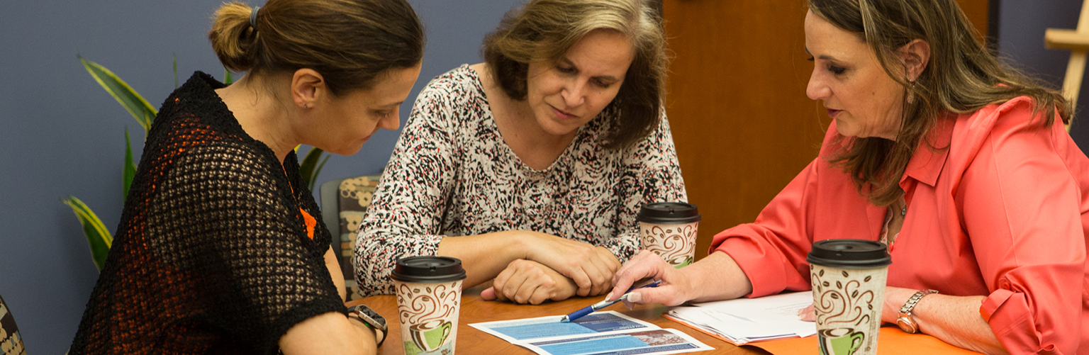 Woman looking at resources on table