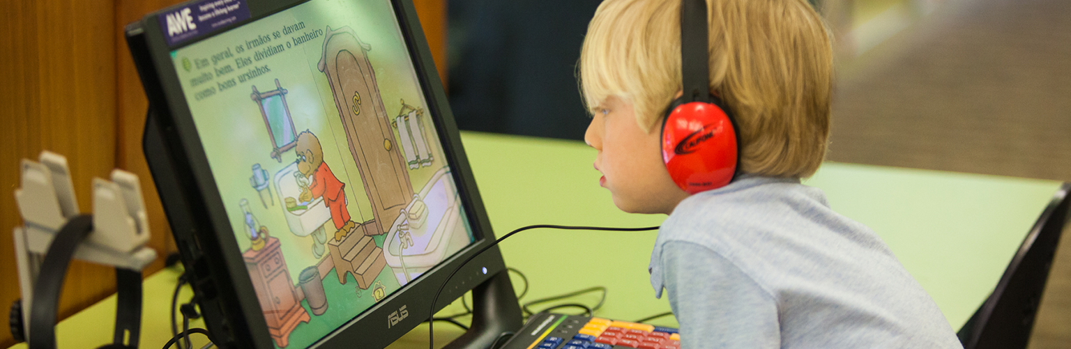 Young Boy at Computer with headphones on