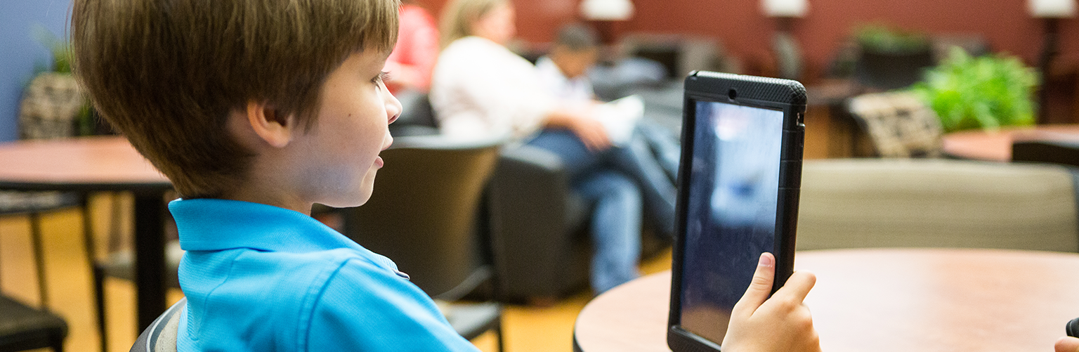 Young boy looking at an iPad