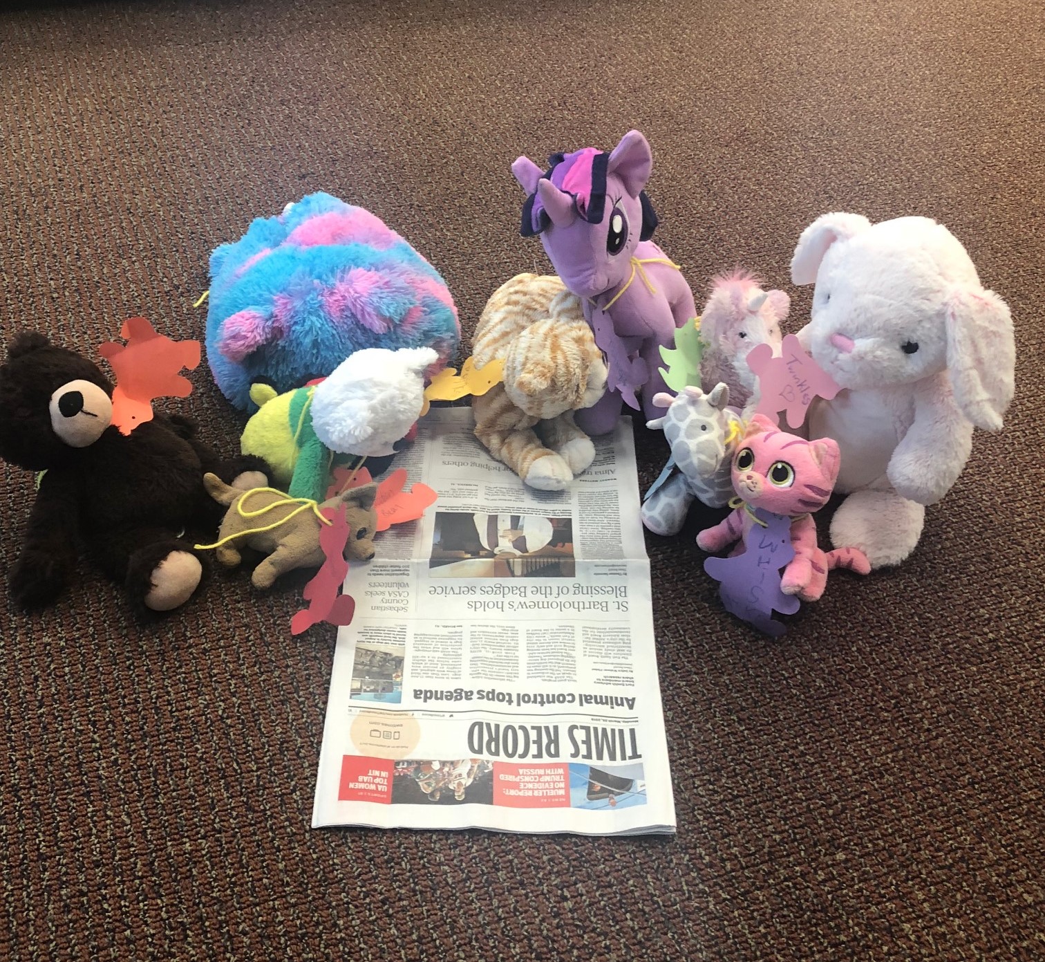 Stuffed animals reading the Times Record