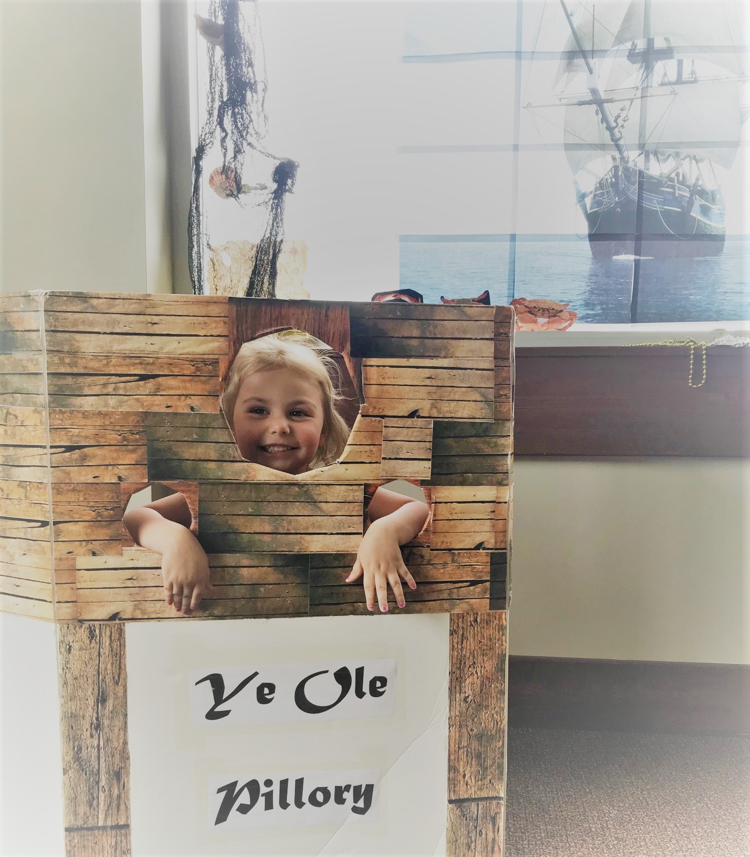 Child taking a picture at a library pirate event.