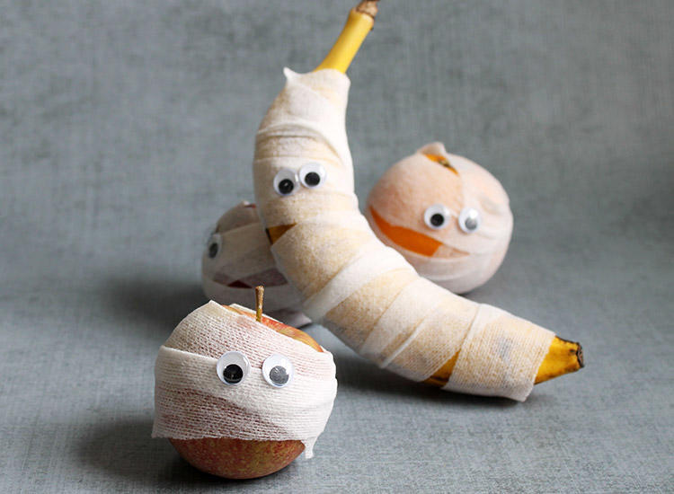 Halloween craft of fruit turned into ghosts.