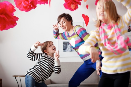 family dancing with valentine hearts