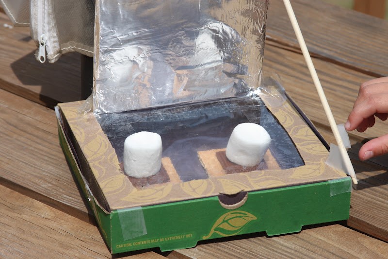 picture of a hand-made solar oven heating s'mores