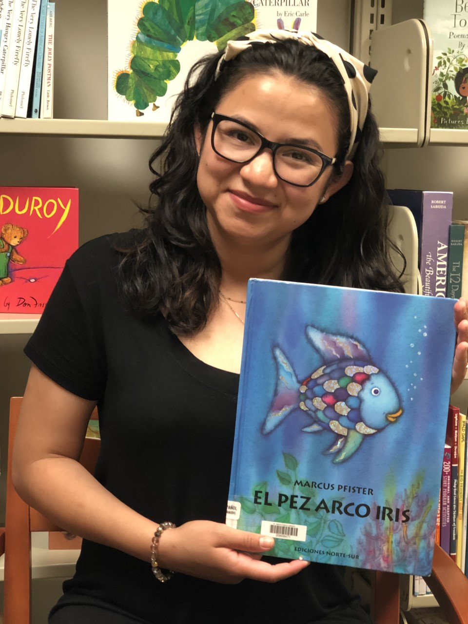 Monica - Storyteller with a copy of "Rainbow Fish"