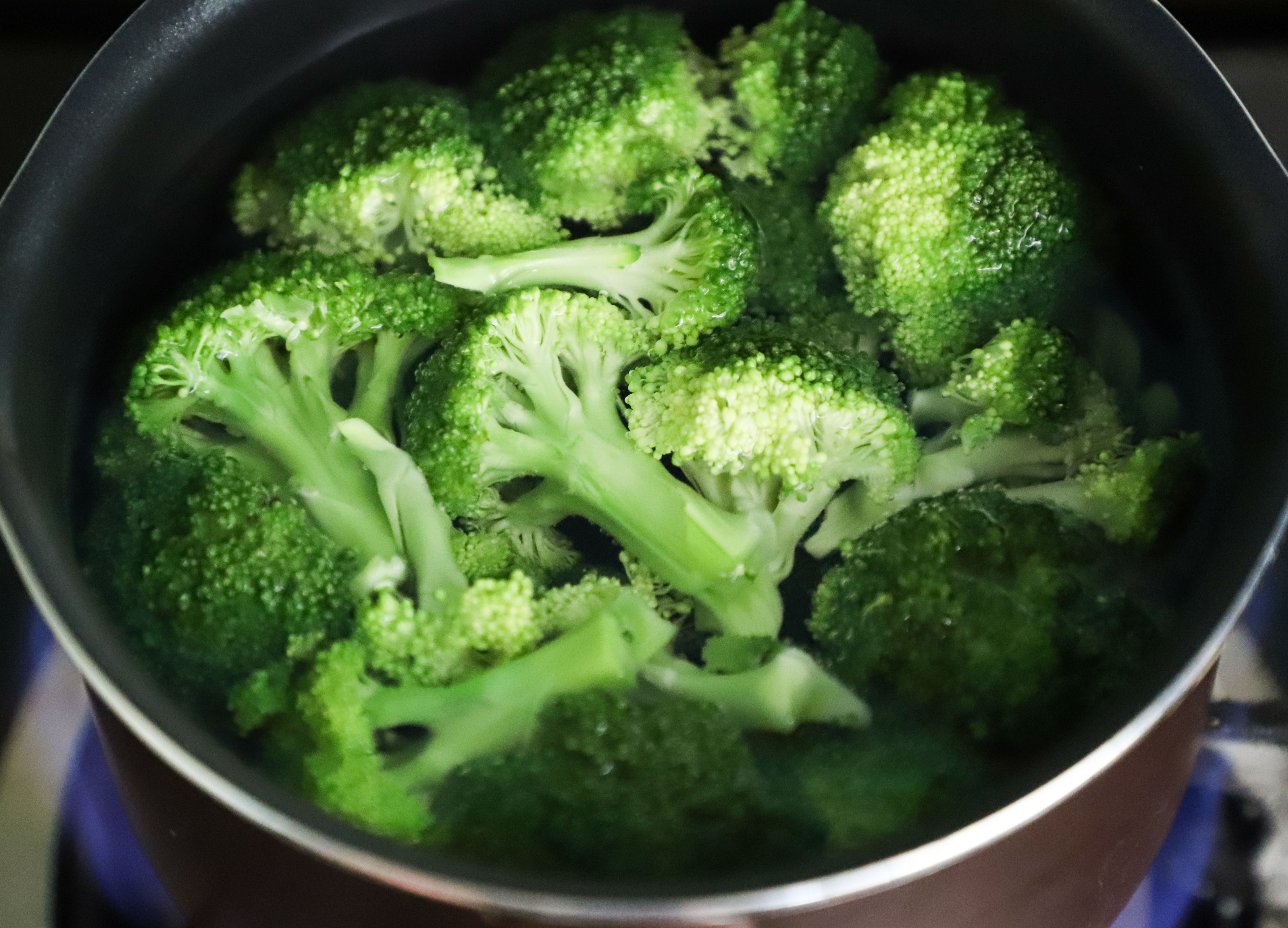Green broccoli in a grey pan. 