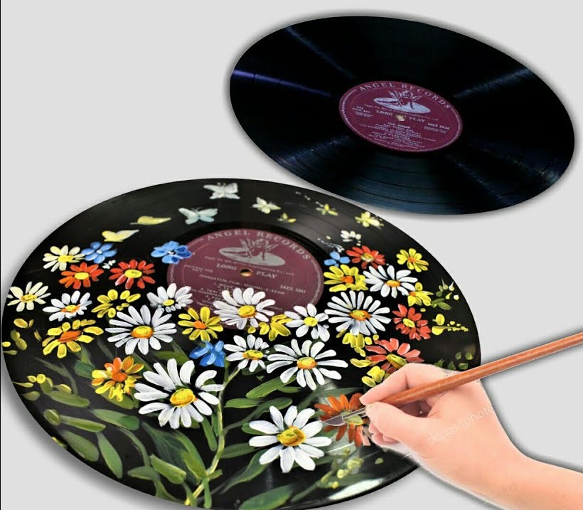 Hand painting on vinyl record with lots of multicolored flowers on it. Also a blank record at the top of the painted record. 