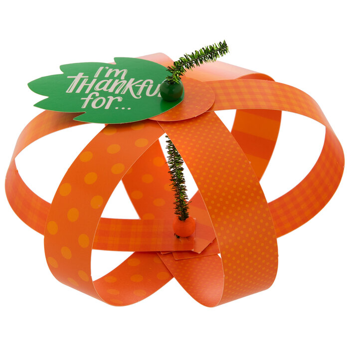 Orange 3D pumpkin with a green thankful tag against a white background 