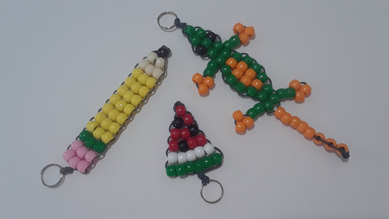Three pony bead keychains against a white back ground. One is a pencil, other is watermelon slice, and the last one is a lizard. 
