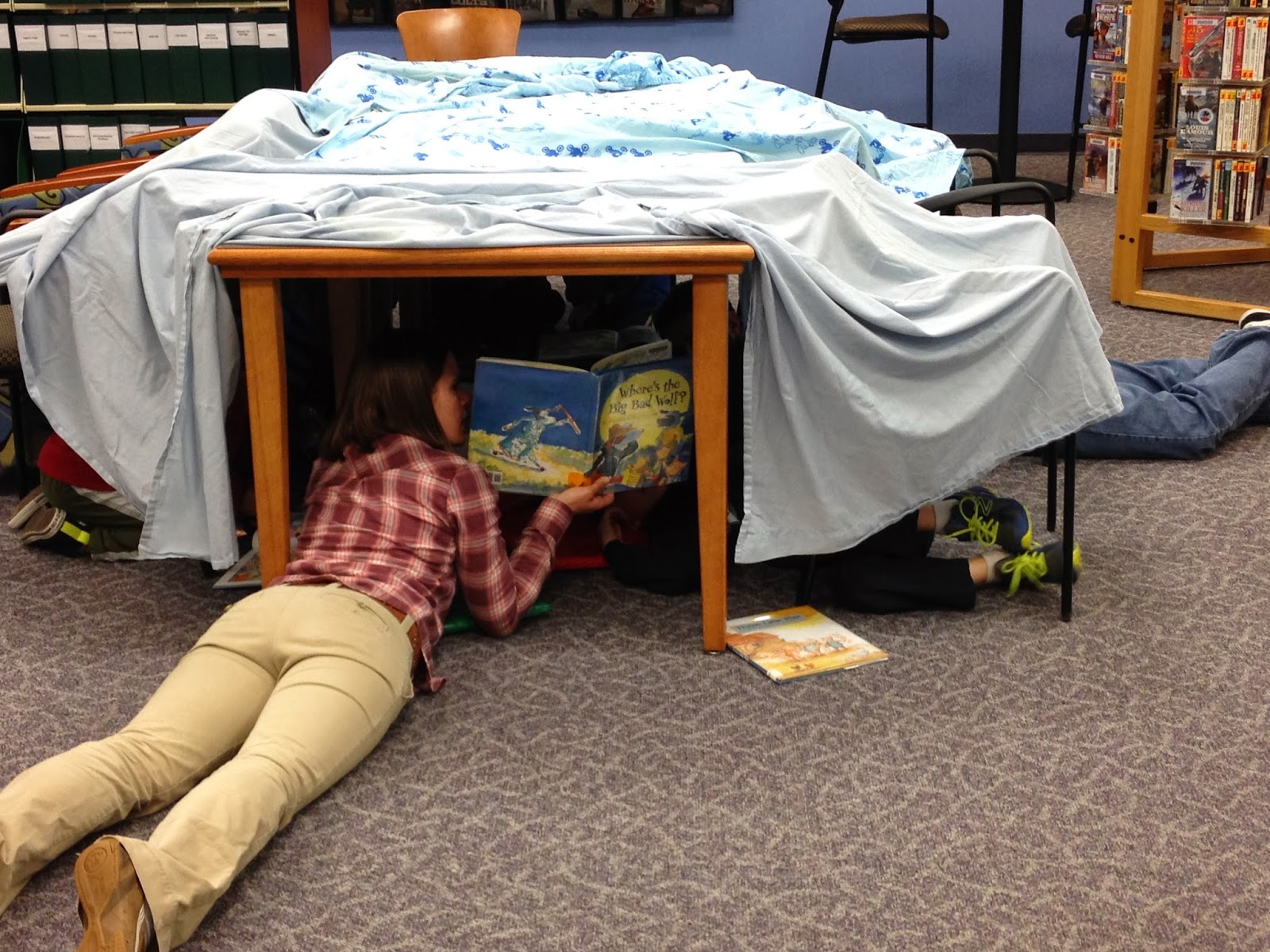 mother reading to kids in a library night "family fort"
