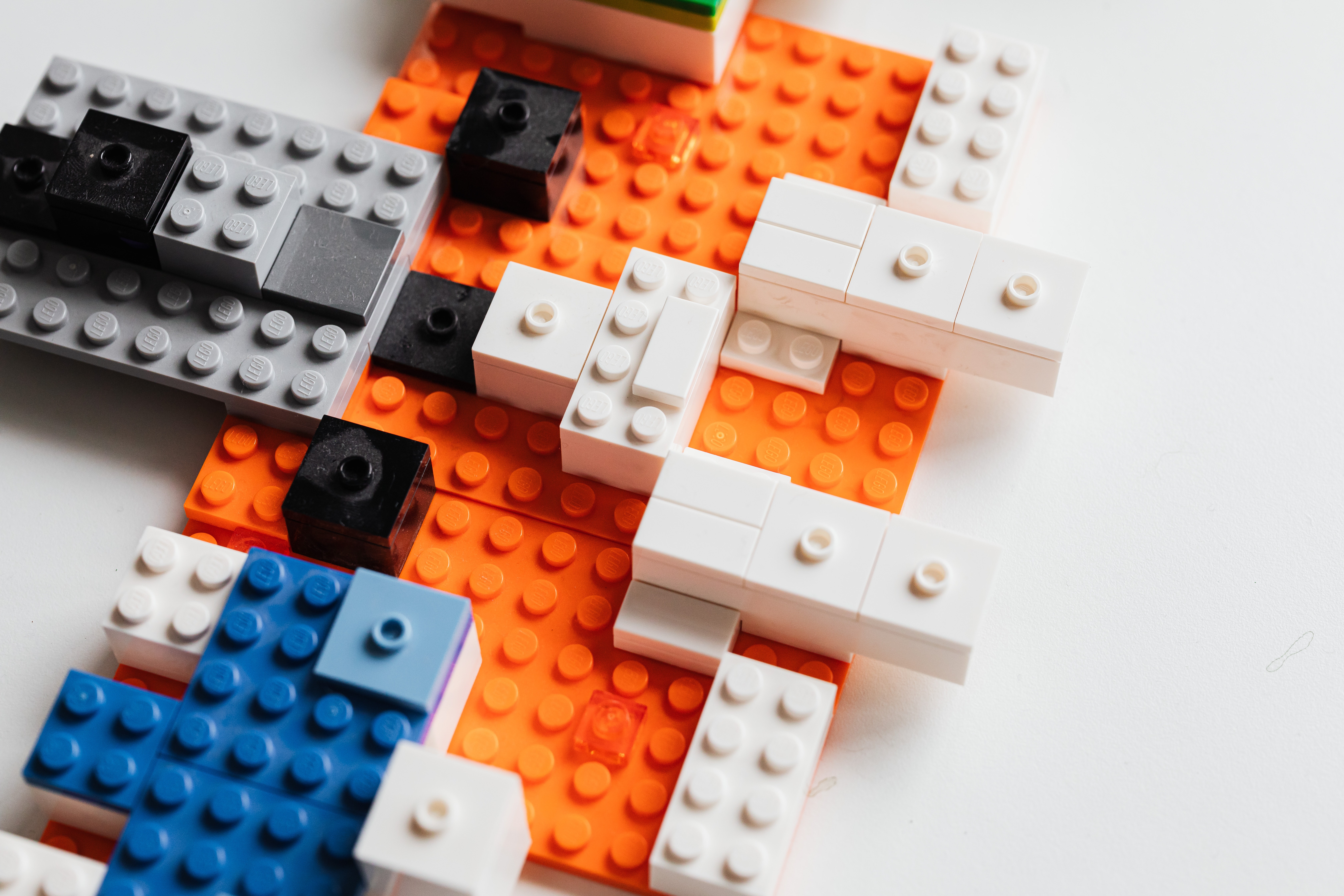 Multicolor lego blocks put together against a white background. 