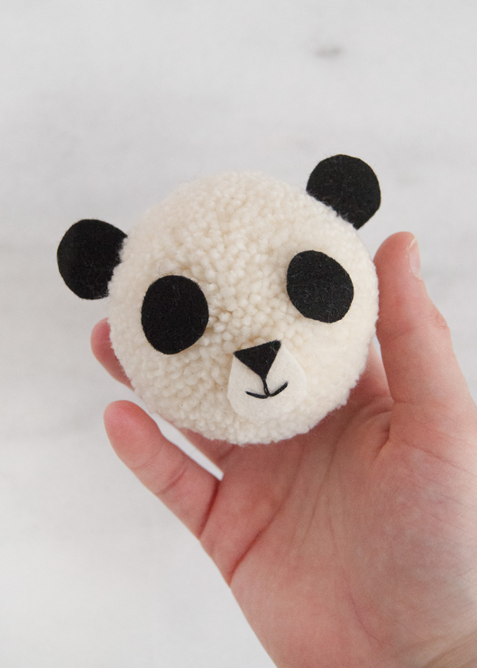 panda head made from white yarn pom pom 