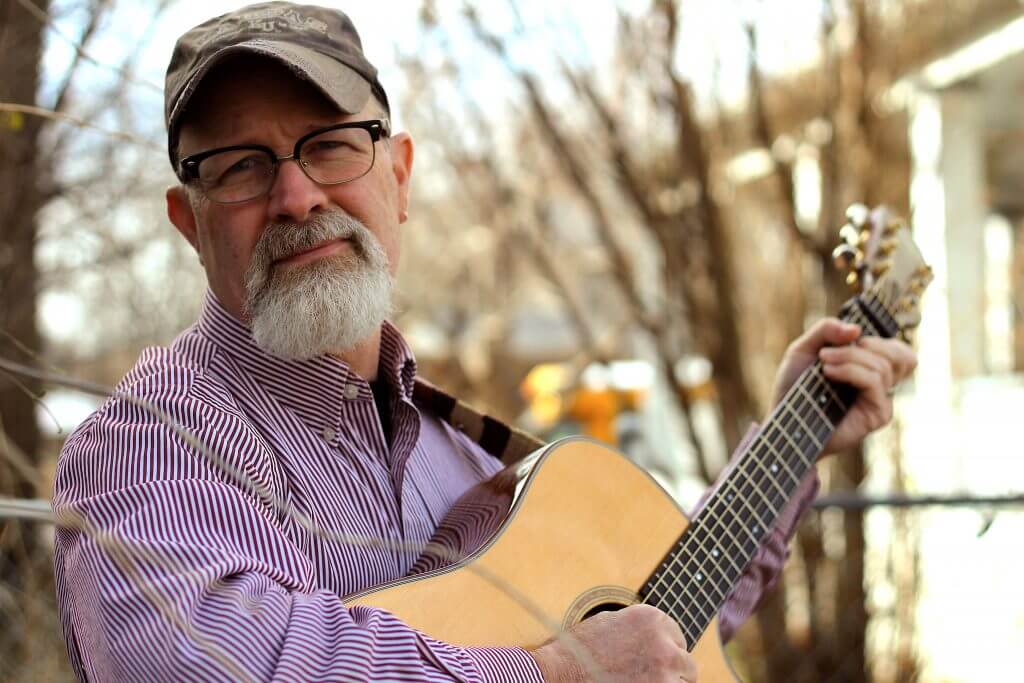 photo of musician Aaron Fowler with his guitar 