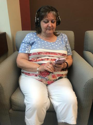 Customer listening to an audiobook on her phone