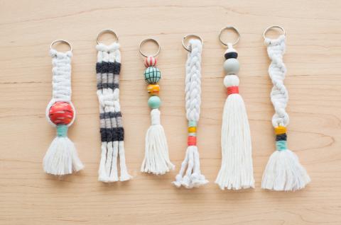 six macramae key chains made out of white cord and colorful accents