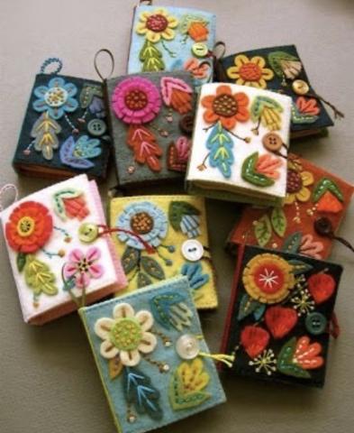 photography of colorful felt-min-journals with flowers on the covers