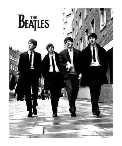 Black and white photo of The Beatles music group walking down the street