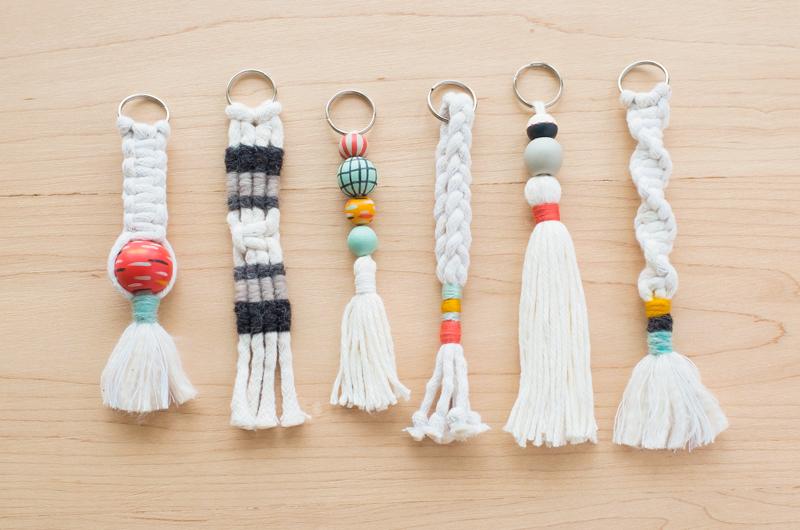 six macramae key chains made out of white cord and colorful accents